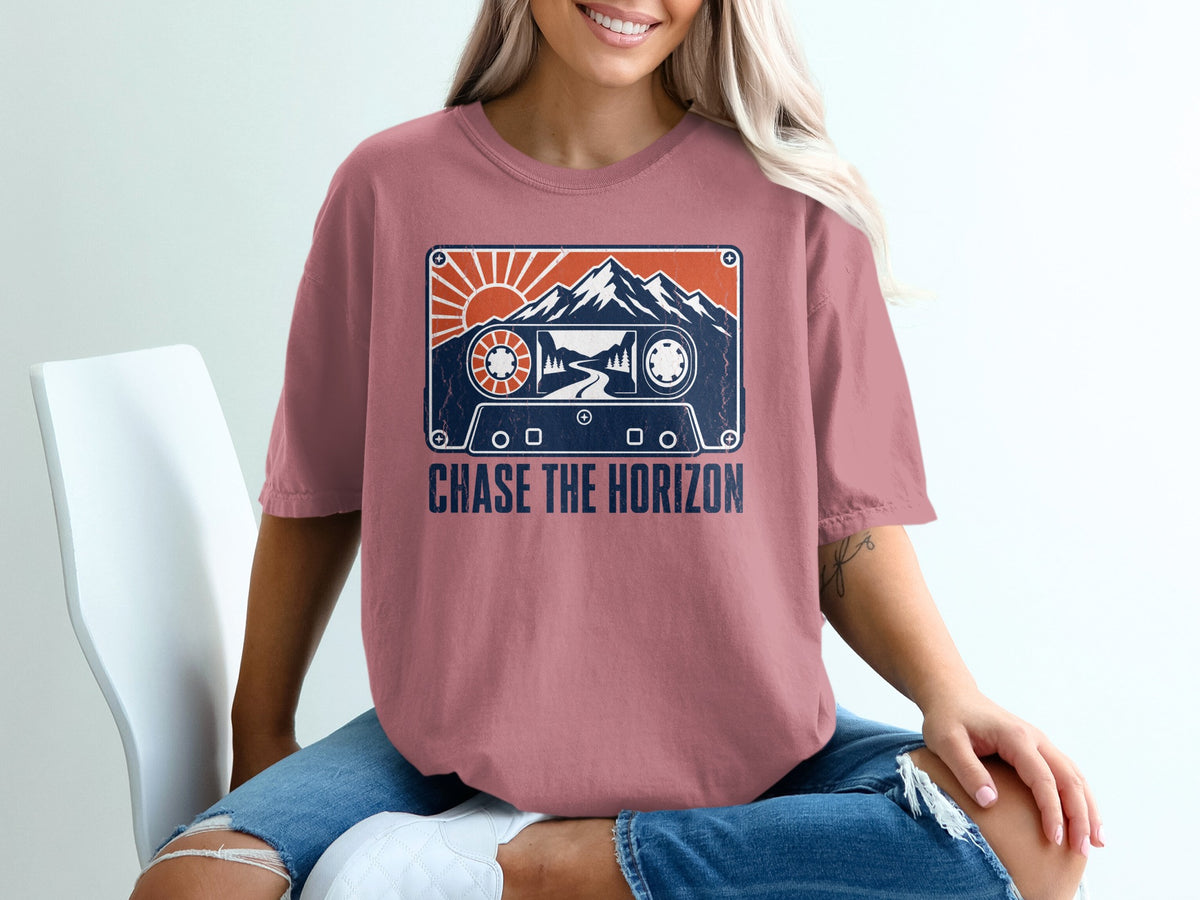 Pink t-shirt with vintage cassette tape graphic and "CHASE THE HORIZON" text.