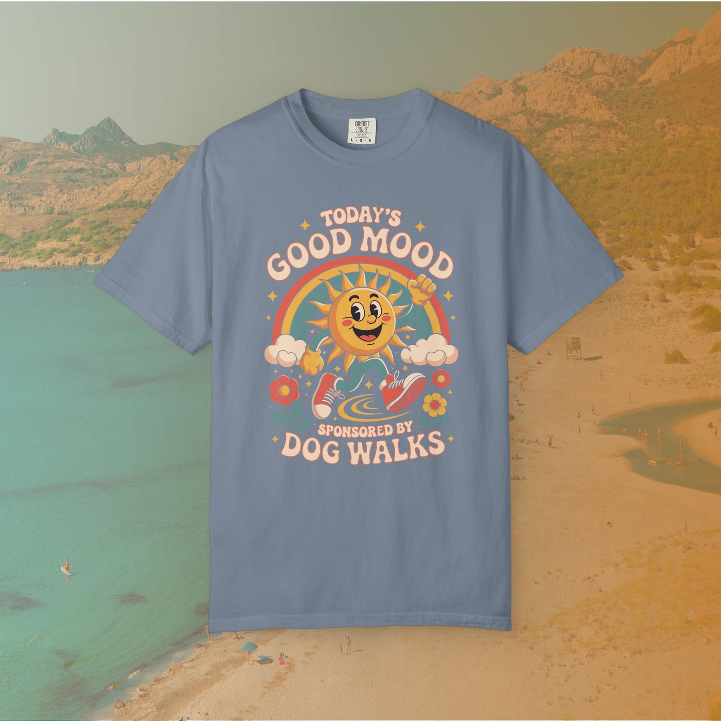 blue t-shirt Retro 70s-style graphic t-shirt featuring a running, happy cartoon sun in sneakers under a rainbow and clouds. The slogan reads: "TODAY'S GOOD MOOD SPONSORED BY DOG WALKS."