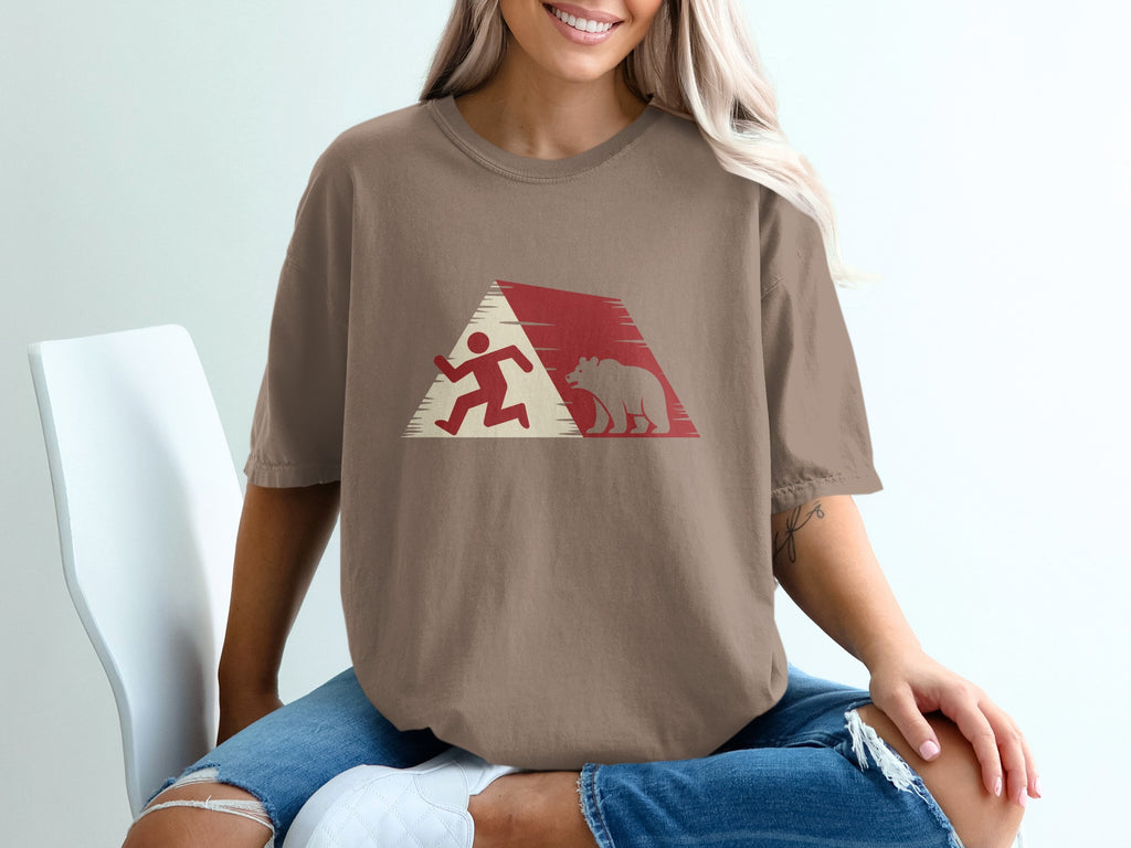 Brown t-shirt with running man and bear graphic within a red and white triangle design.