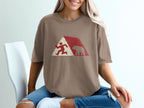 Brown t-shirt with running man and bear graphic within a red and white triangle design.