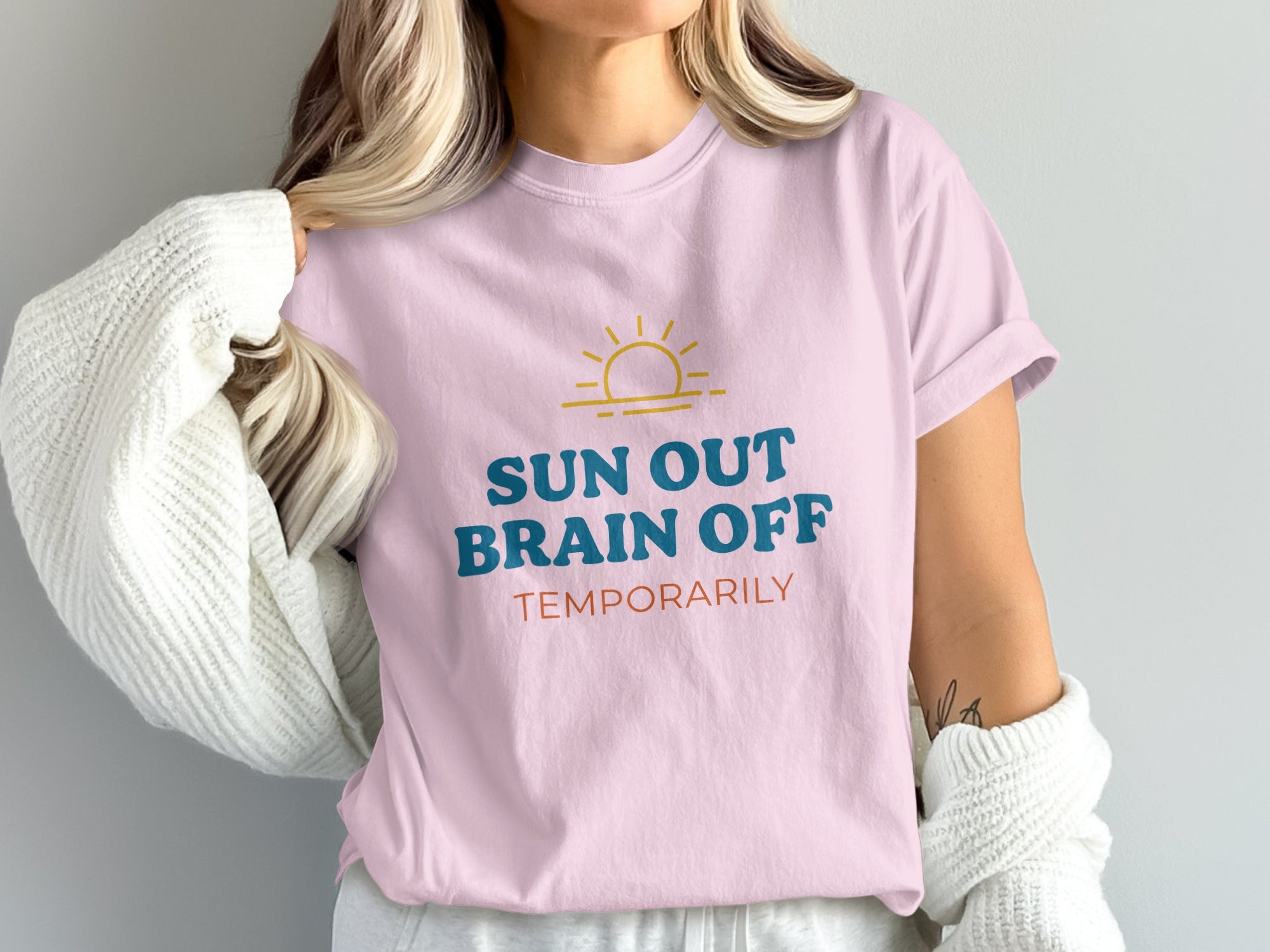 Pink t-shirt with "SUN OUT BRAIN OFF TEMPORARILY" text and sun graphic.