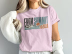 Pink t-shirt with retro "From Summit to Sea" graphic featuring mountains and ocean.