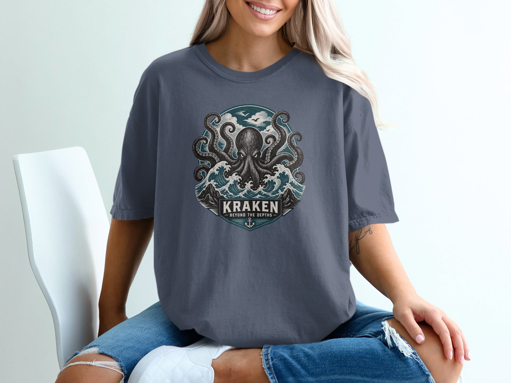 Dark blue t-shirt featuring a kraken and waves graphic with text.