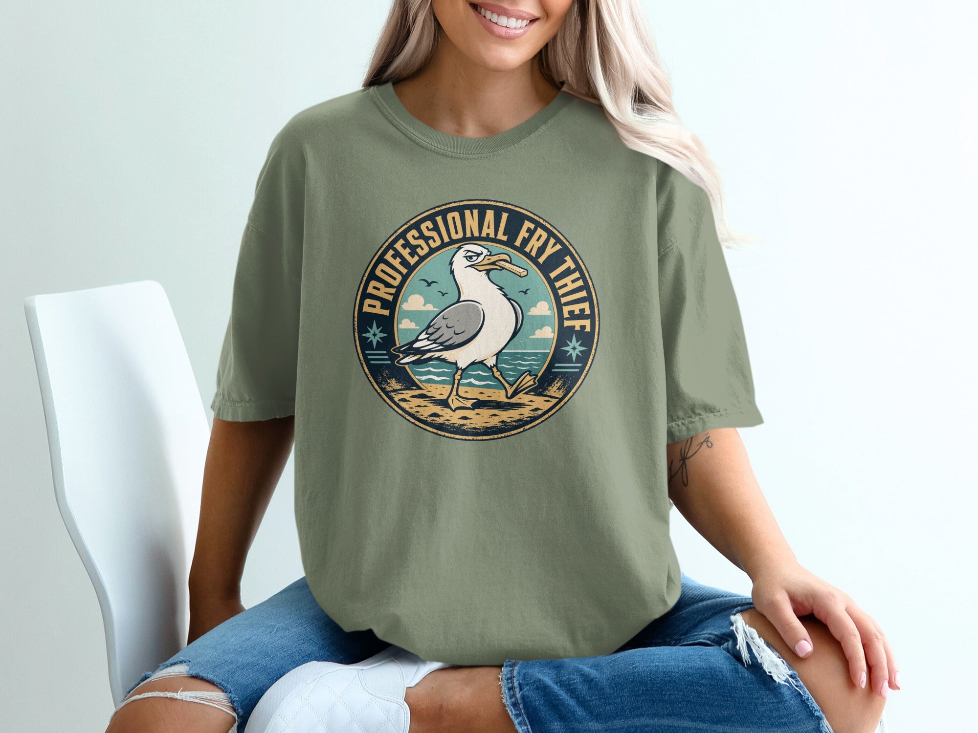 Seagull with french fry in beak and text PROFESSIONAL FRY THIEF on shirt.