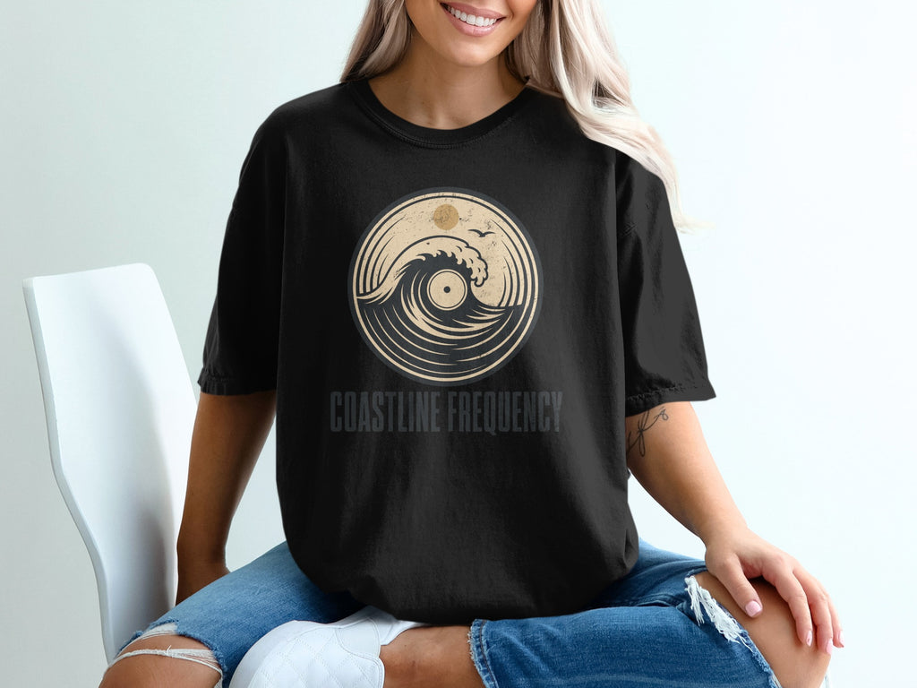 Black t-shirt with "COASTLINE FREQUENCY" and circular wave design.