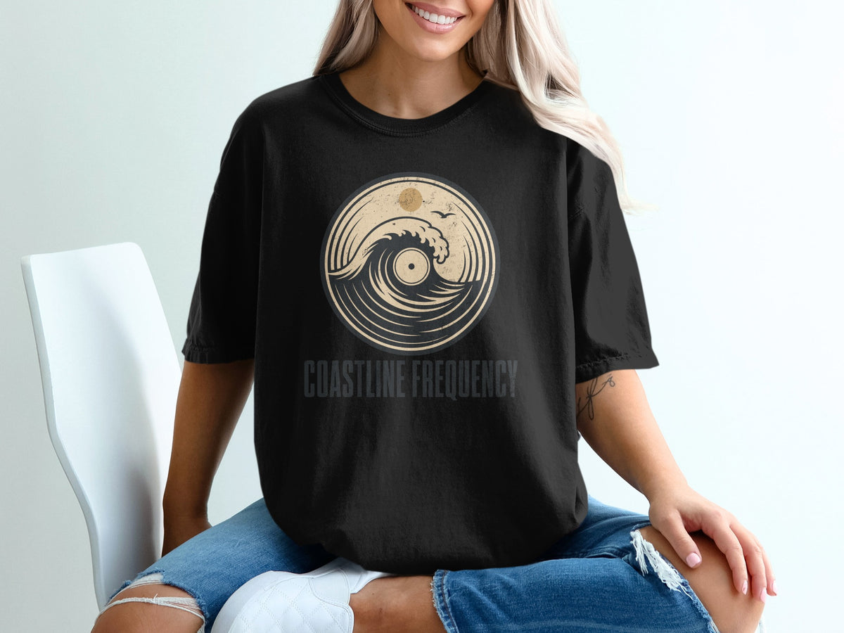 Black t-shirt with "COASTLINE FREQUENCY" and circular wave design.