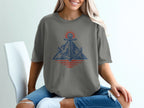 Graphic t-shirt with anchor, mountain, and sun graphic in blue and red.