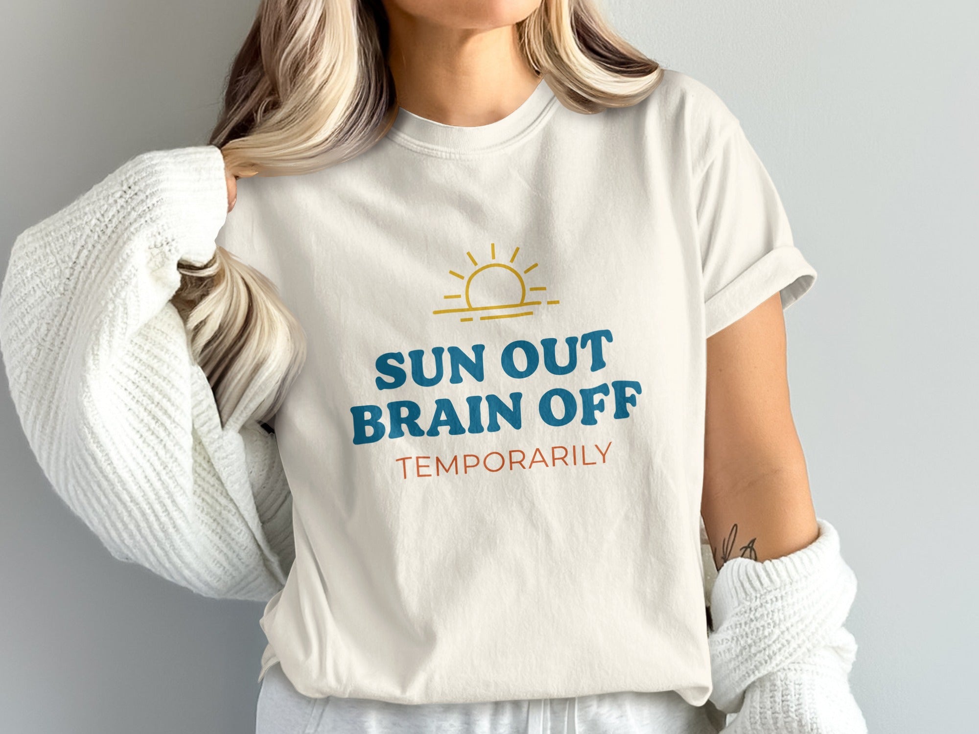 Cream t-shirt with "SUN OUT BRAIN OFF TEMPORARILY" text and a sun graphic.