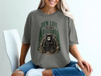 Graphic t-shirt with a bear and "Den Life Do Not Disturb" text.