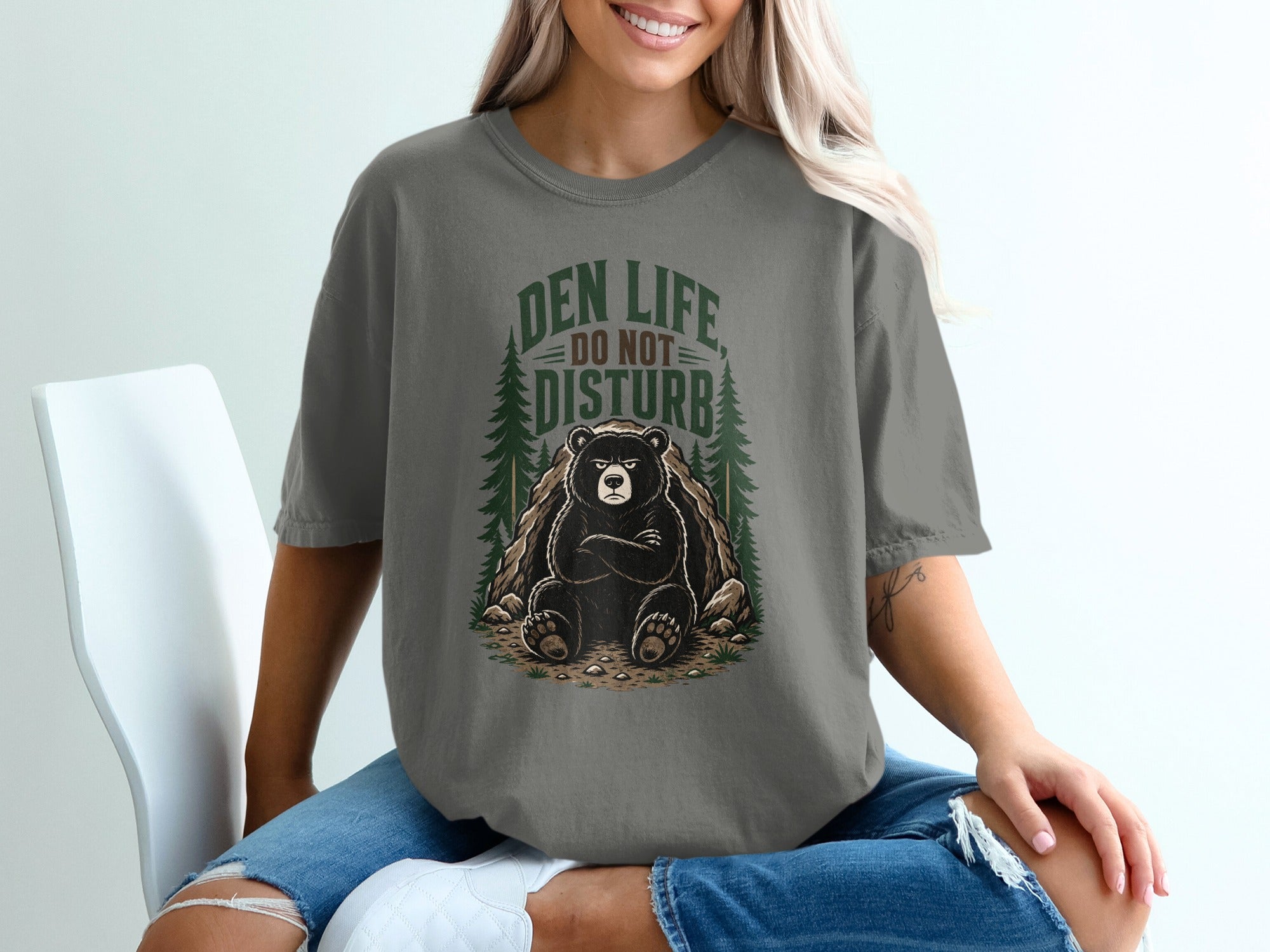 Graphic t-shirt with a bear and "Den Life Do Not Disturb" text.