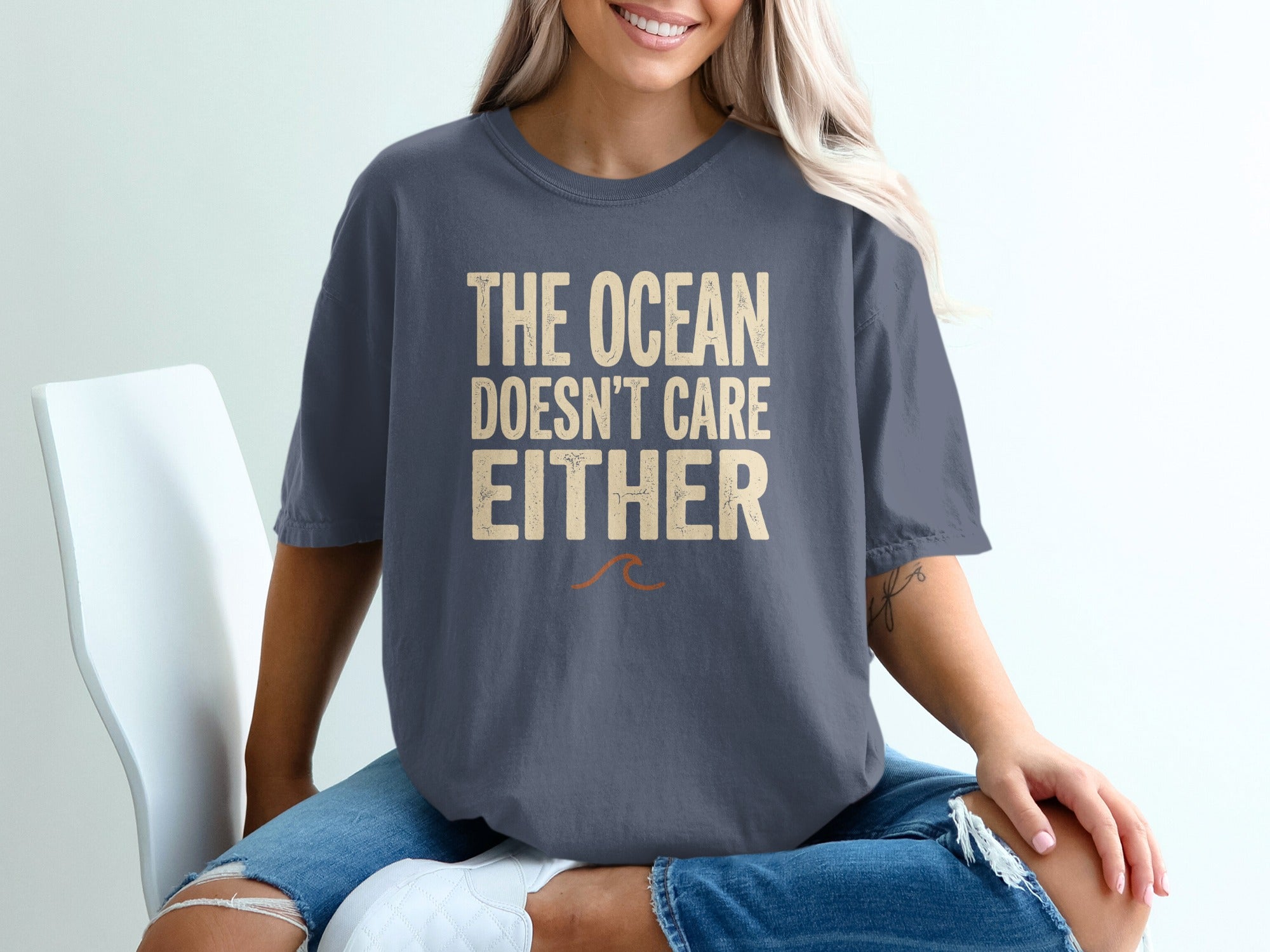 Dark grey t-shirt with "The Ocean Doesn't Care Either" text.