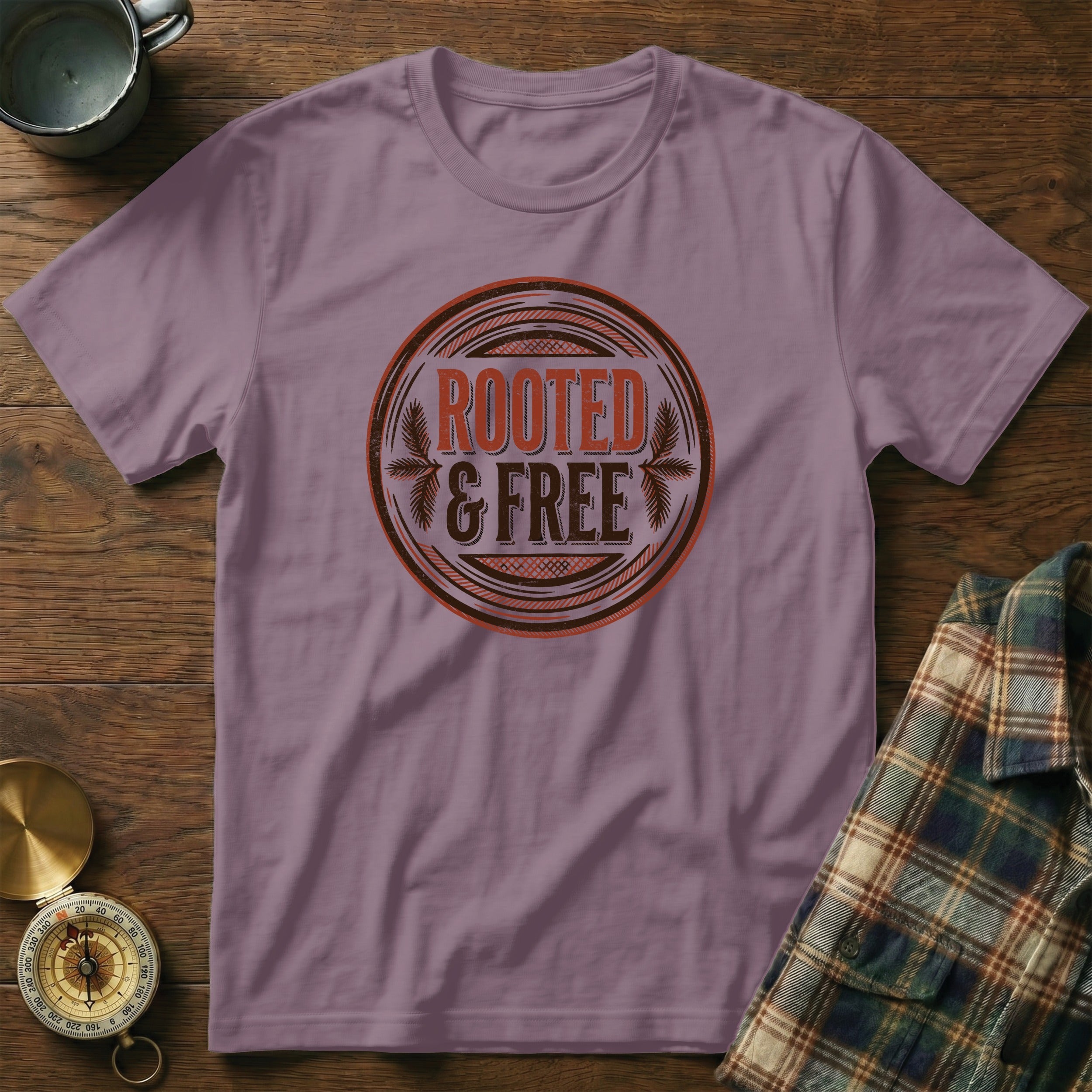 Purple t-shirt with "ROOTED & FREE" graphic in a circular emblem.