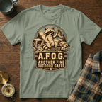 Green t-shirt with a raccoon graphic and text "-A.F.O.G.- ANOTHER FINE OUTDOOR GAFFE".