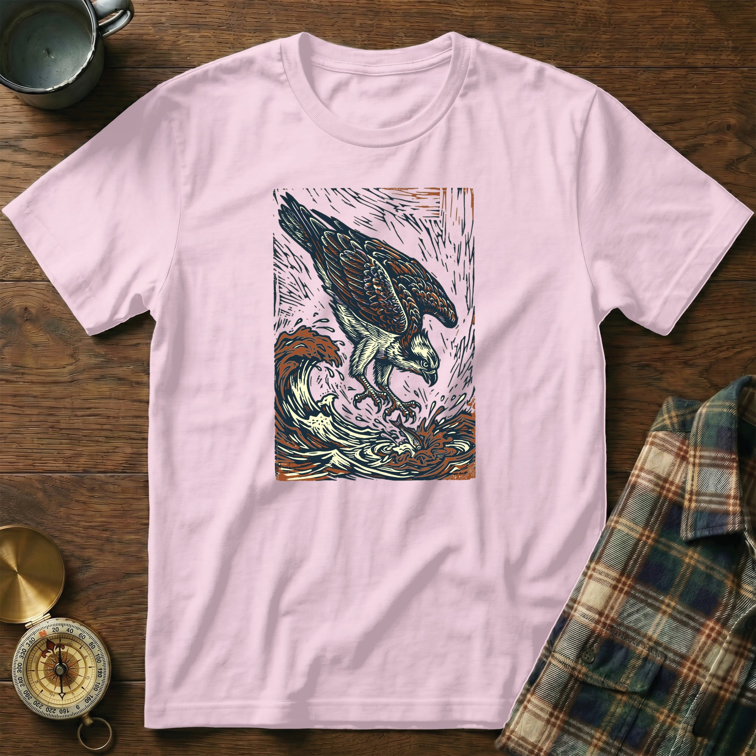 Pink t-shirt with graphic of an osprey diving into waves.