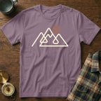 Purple t-shirt with abstract mountain line art and sun graphic.