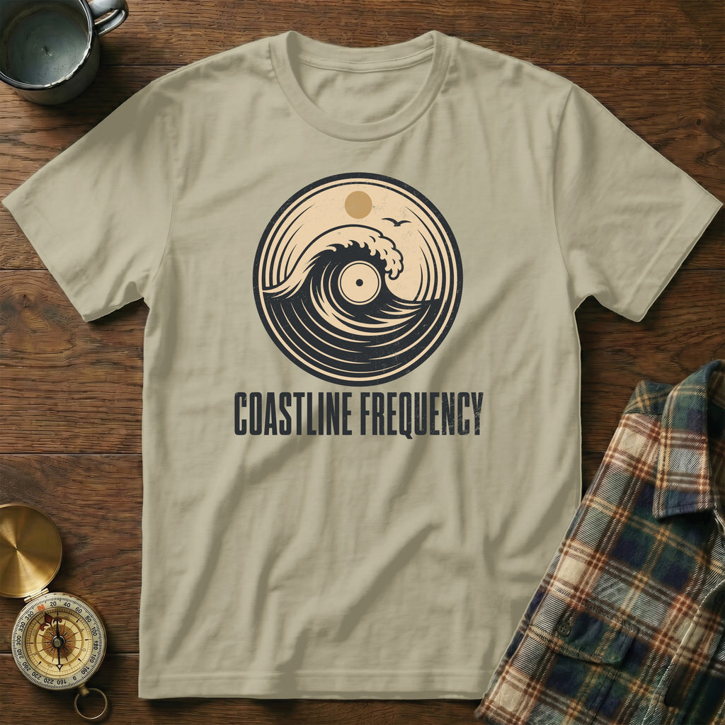 Light tan t-shirt with circular wave and vinyl graphic. COASTLINE FREQUENCY text.