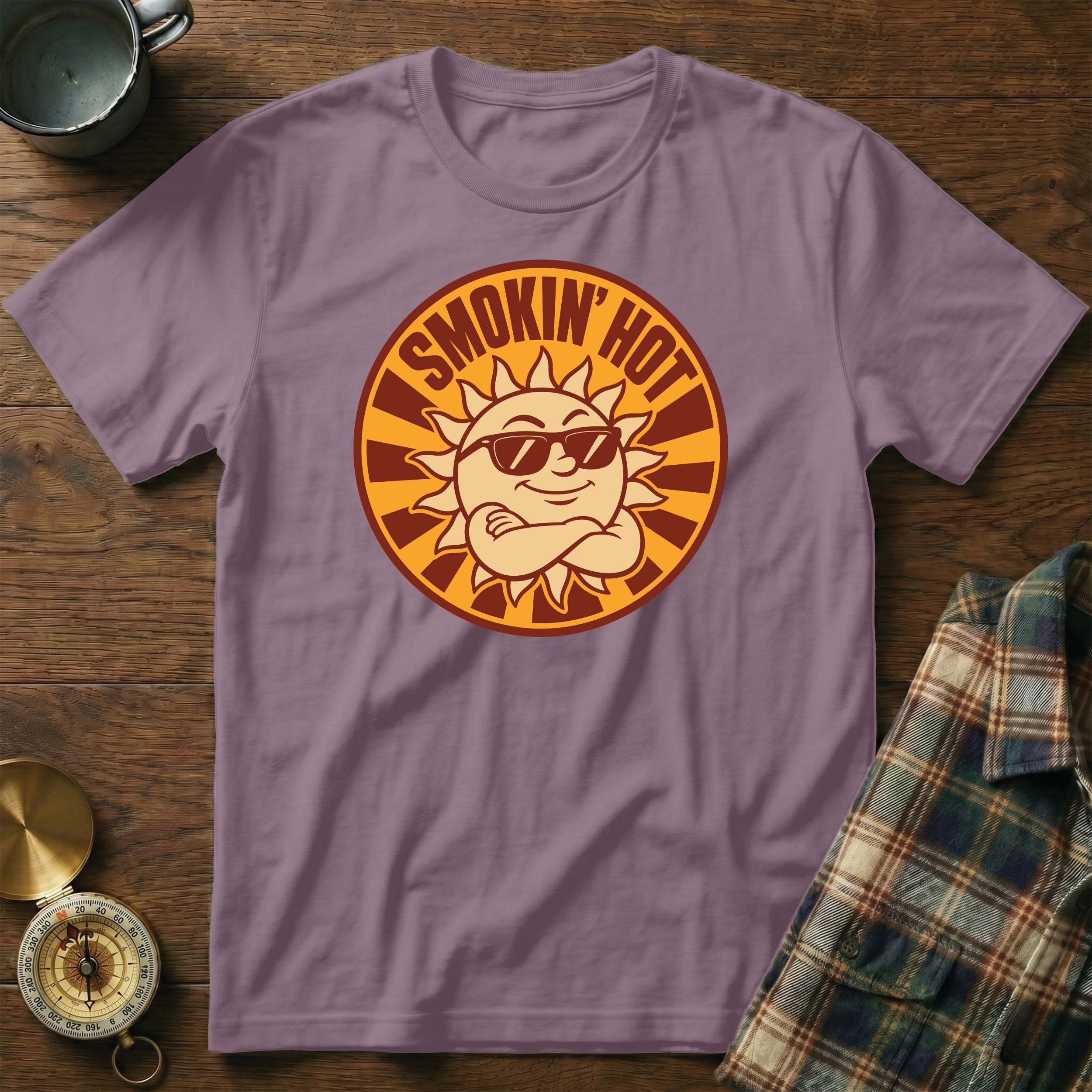 Purple t-shirt with a circular graphic of a cool sun wearing sunglasses and the text "Smokin' Hot."