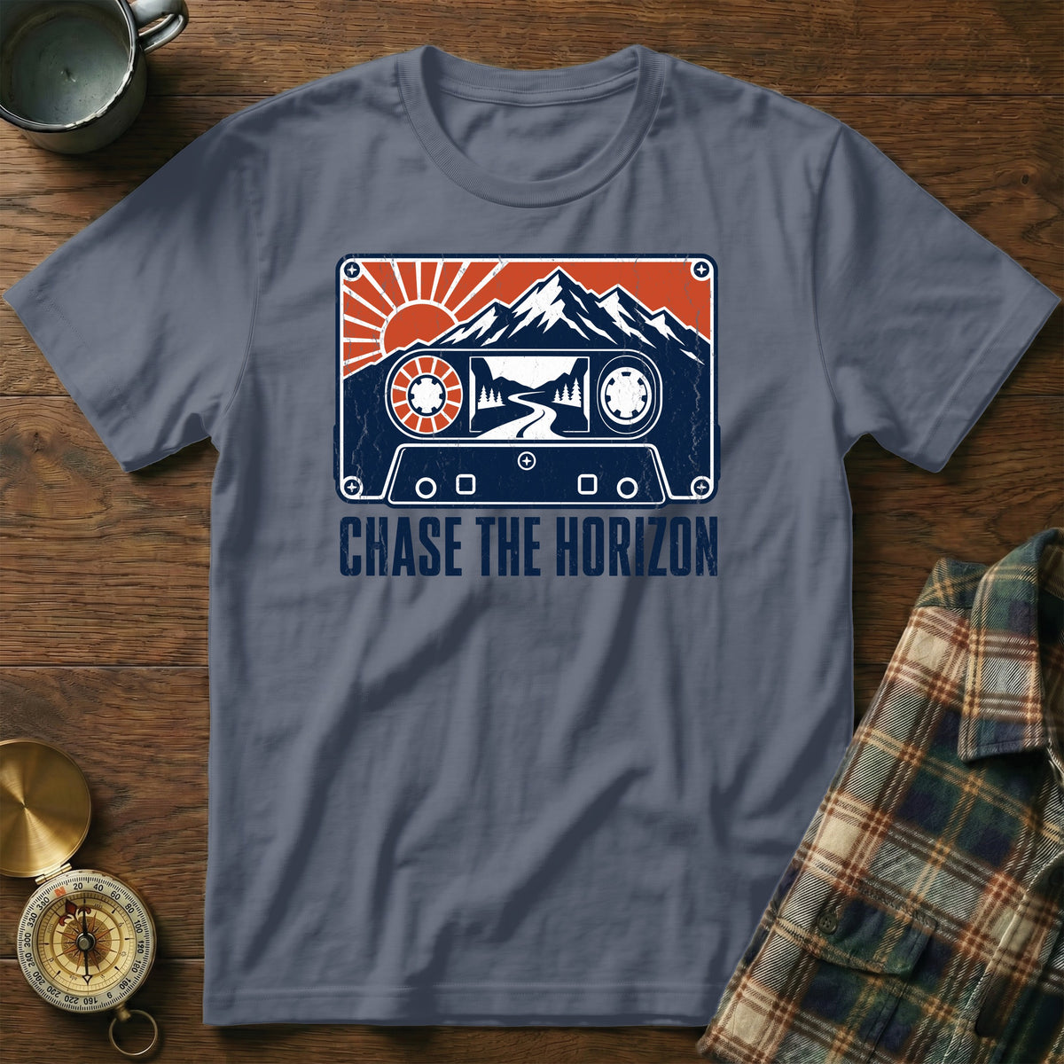 T-shirt with cassette tape graphic featuring mountains, road, sun, and text "CHASE THE HORIZON".