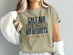 Tan t-shirt with "Salt Air Bad Decisions No Regrets" text and compass graphic.