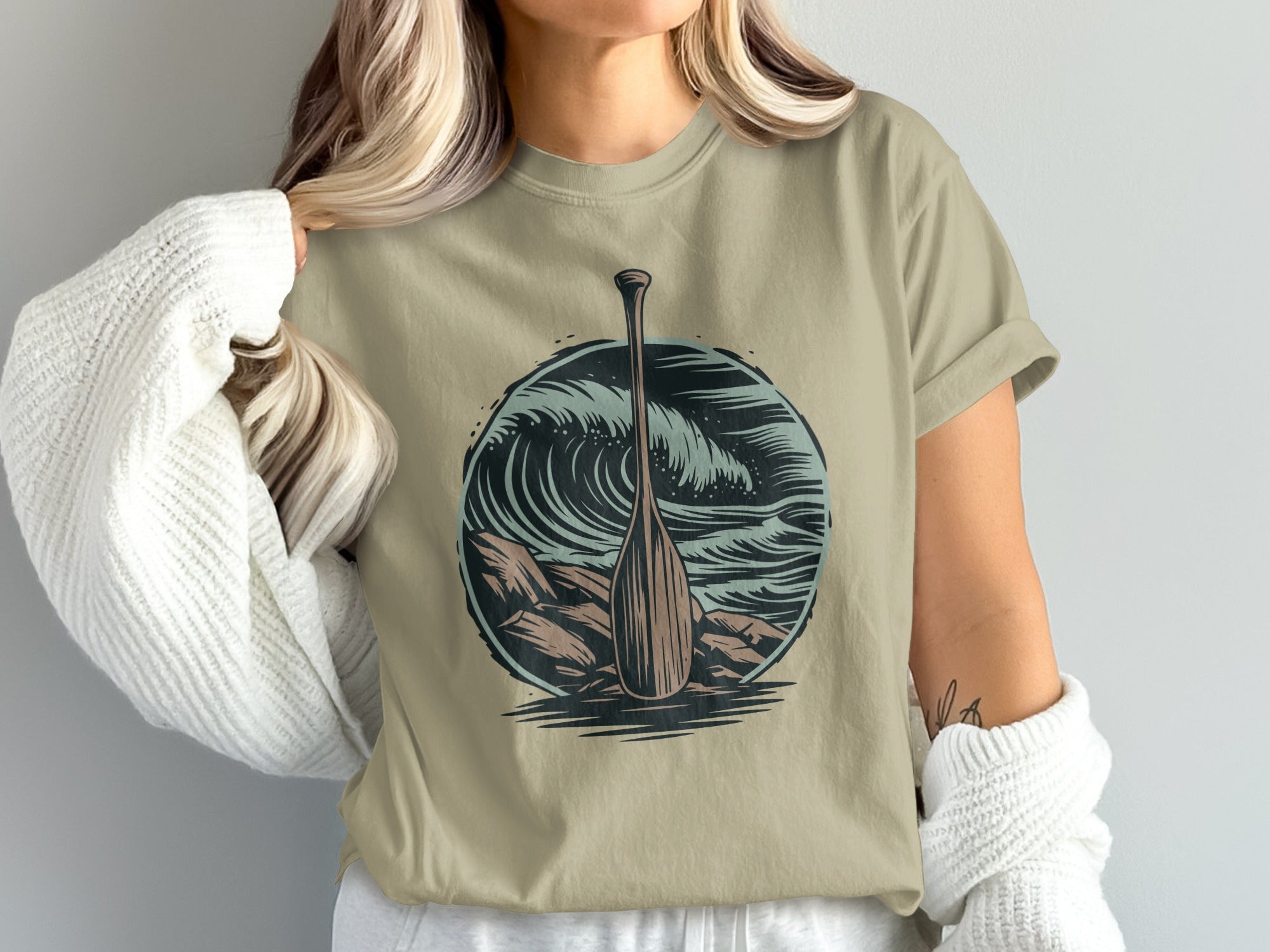 Crewneck t-shirt with a circular graphic of a paddle and waves.