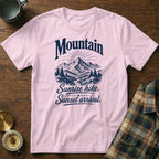 Light pink t-shirt featuring a navy mountain graphic and text reading Mountain Sunrise hike. Sunset arrival.