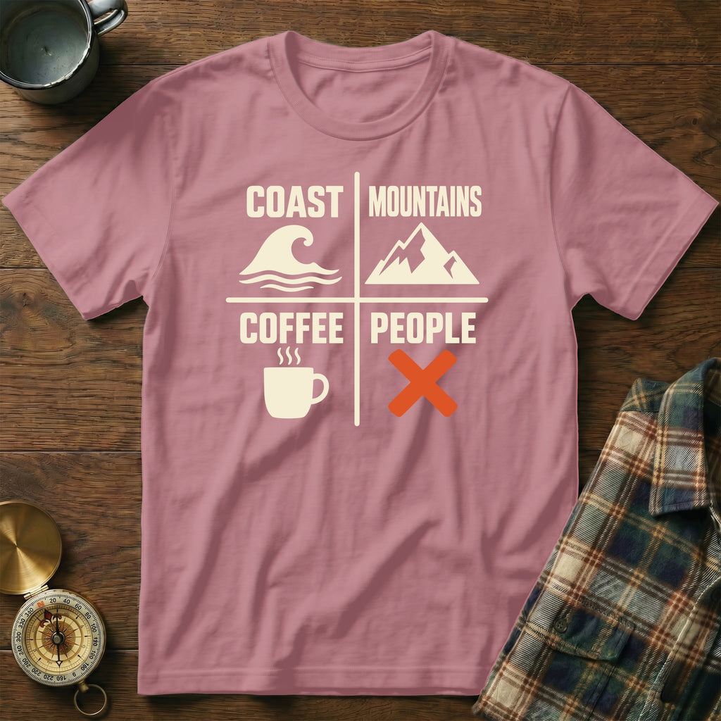 Pink t-shirt with text "Coast Mountains Coffee People" and icons of wave, mountain, coffee cup, and crossed out.