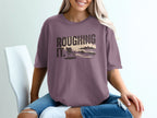 Purple t-shirt with "ROUGHING IT." text and a beach scene.