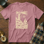 Pink t-shirt with lighthouse, sailboat, and waves graphic design.