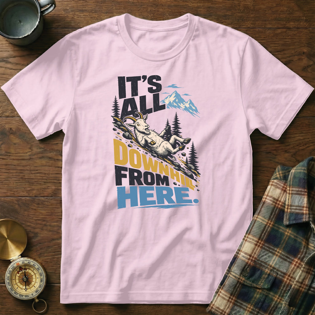 Light pink t-shirt featuring a graphic of a goat sliding downhill with the text "IT'S ALL DOWNHILL FROM HERE."