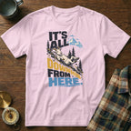 Light pink t-shirt featuring a graphic of a goat sliding downhill with the text "IT'S ALL DOWNHILL FROM HERE."
