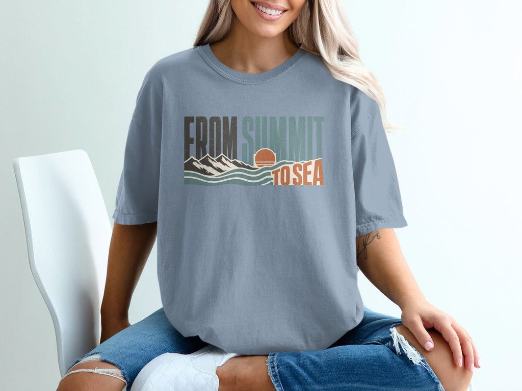 Blue t-shirt with "FROM SUMMIT TO SEA" graphic featuring mountains, waves, and sun.