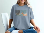 Blue t-shirt with "FROM SUMMIT TO SEA" graphic featuring mountains, waves, and sun.