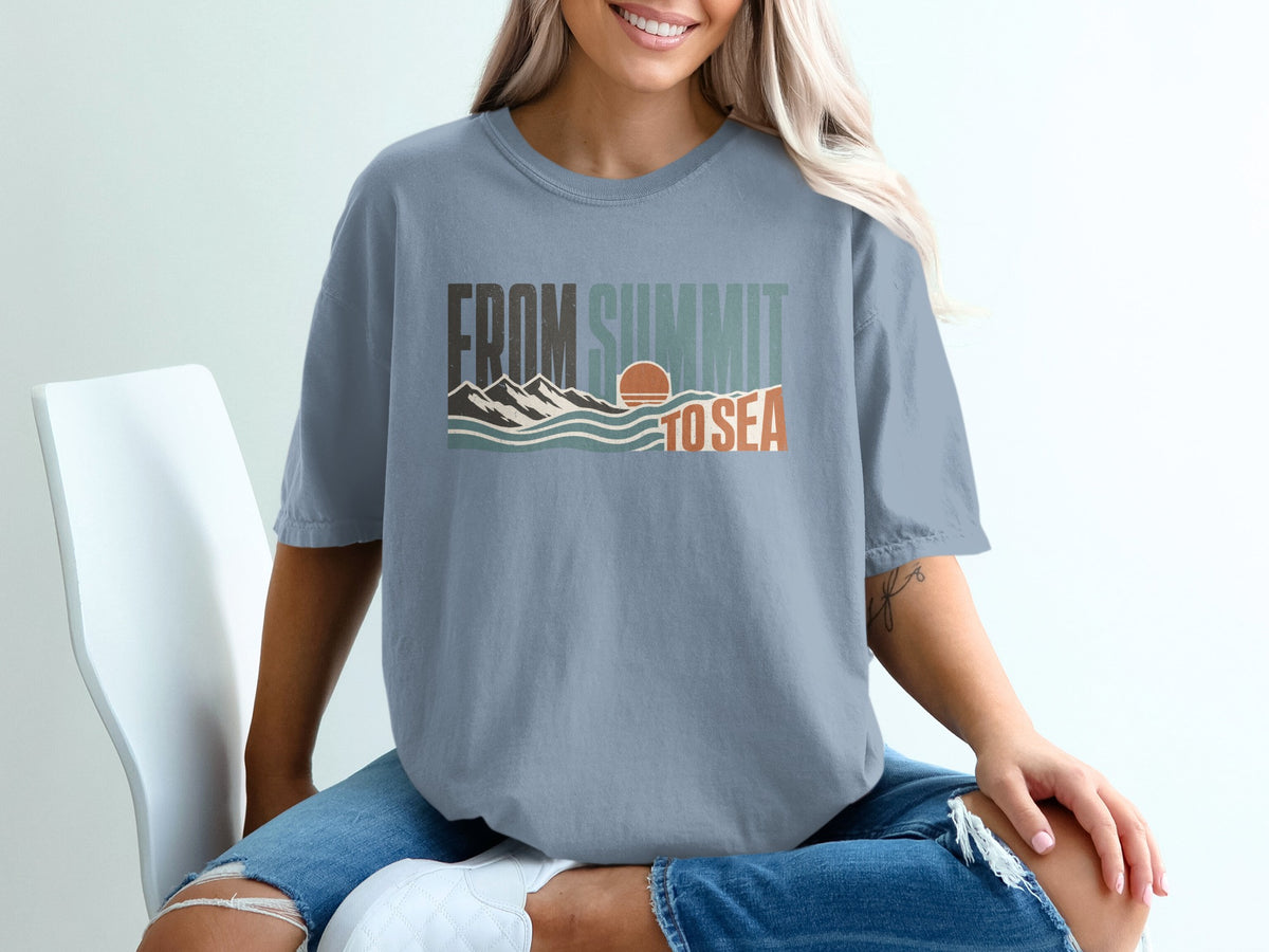 Blue t-shirt with "FROM SUMMIT TO SEA" graphic featuring mountains, waves, and sun.