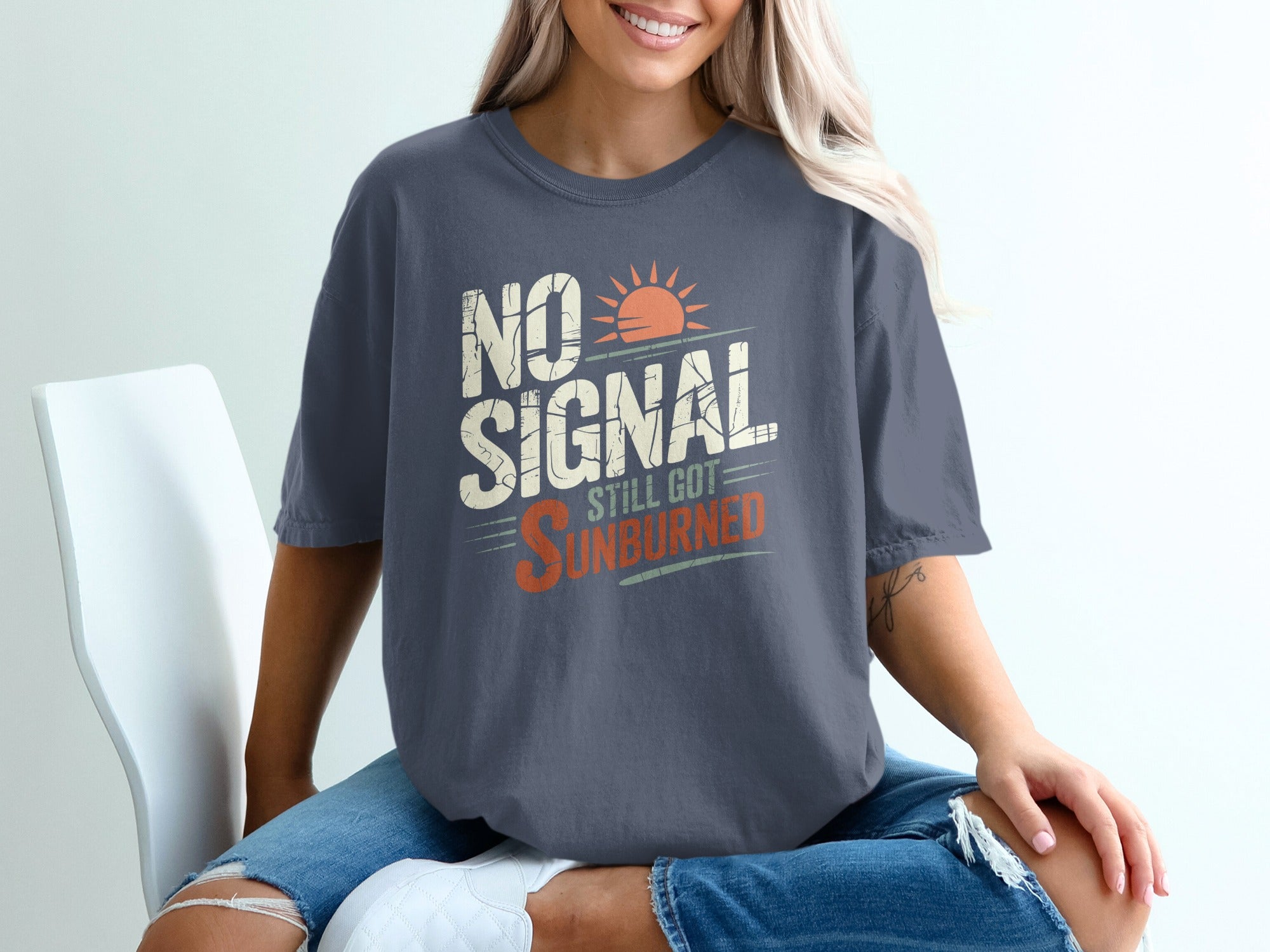 Dark grey t-shirt with "NO SIGNAL STILL GOT SUNBURNED" text and sun graphic.