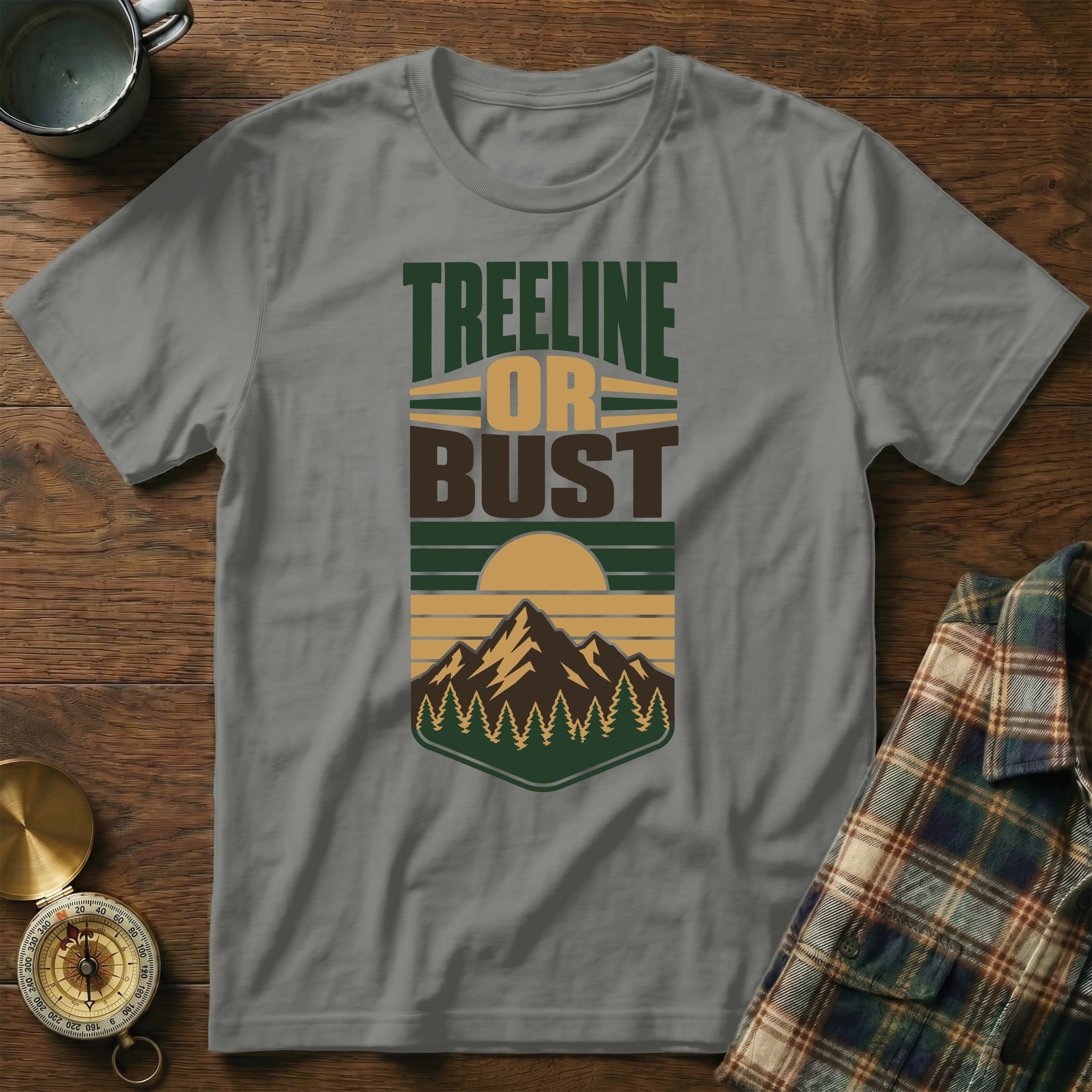 Gray t-shirt with "Treeline Or Bust" text and mountain landscape design.