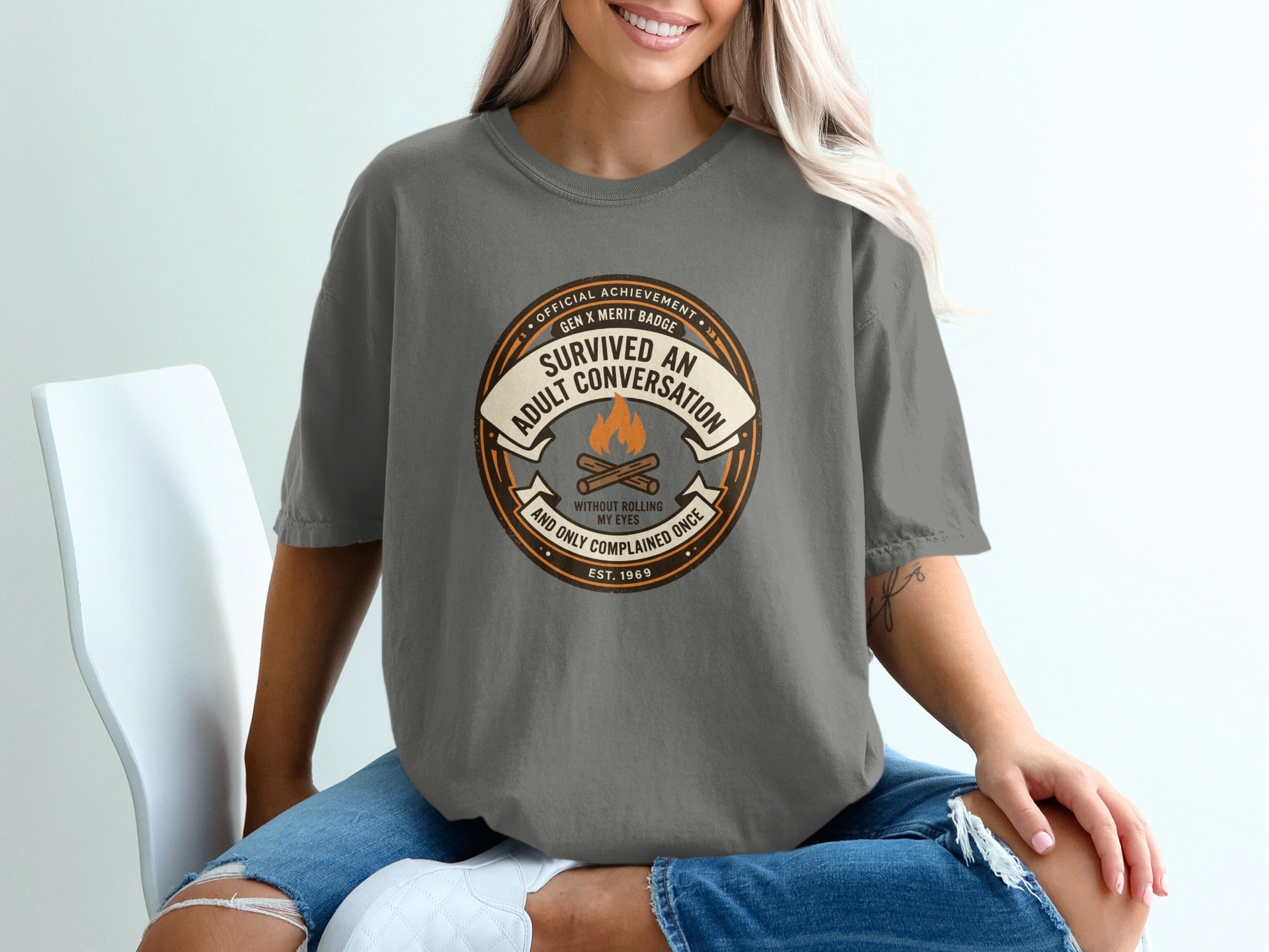 Gray t-shirt with "Survived An Adult Conversation" badge and "Est. 1969".