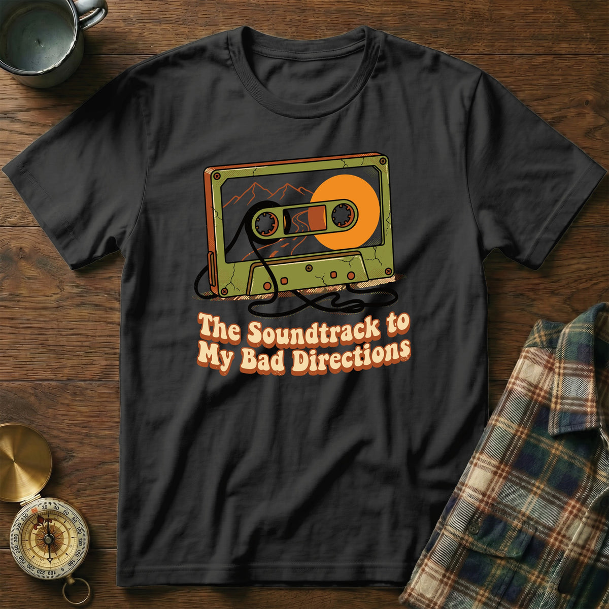 Black t-shirt with graphic of cassette tape and text "The Soundtrack to My Bad Directions".