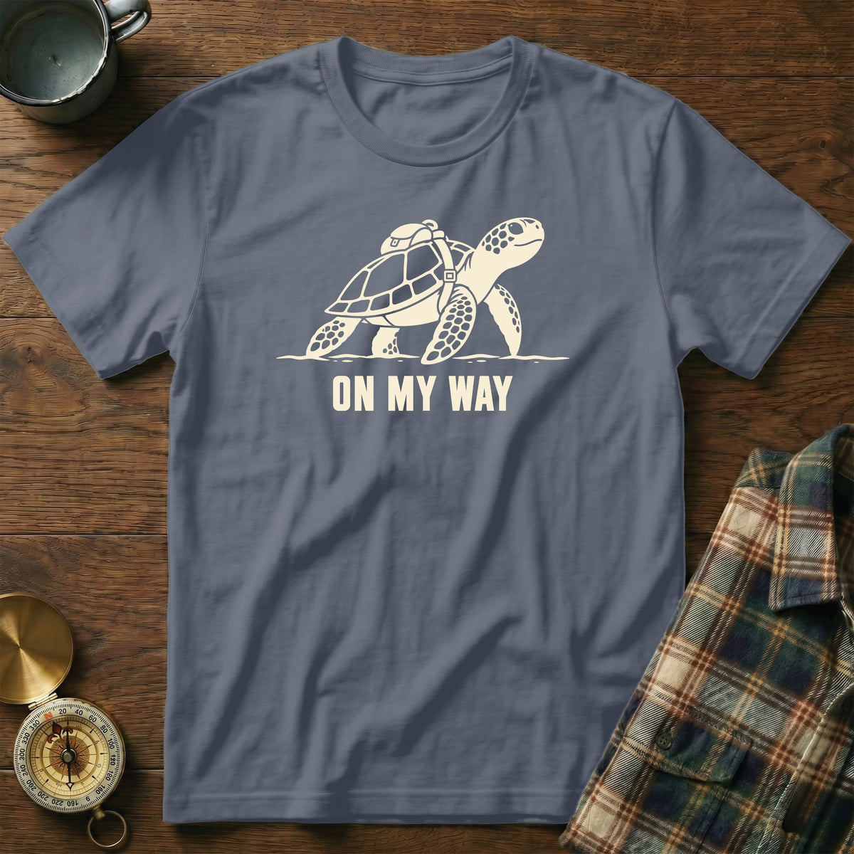 T-shirt with a graphic of a sea turtle wearing a backpack and the text "ON MY WAY".