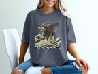 Dark blue t-shirt with a leaping whale and crashing waves graphic.