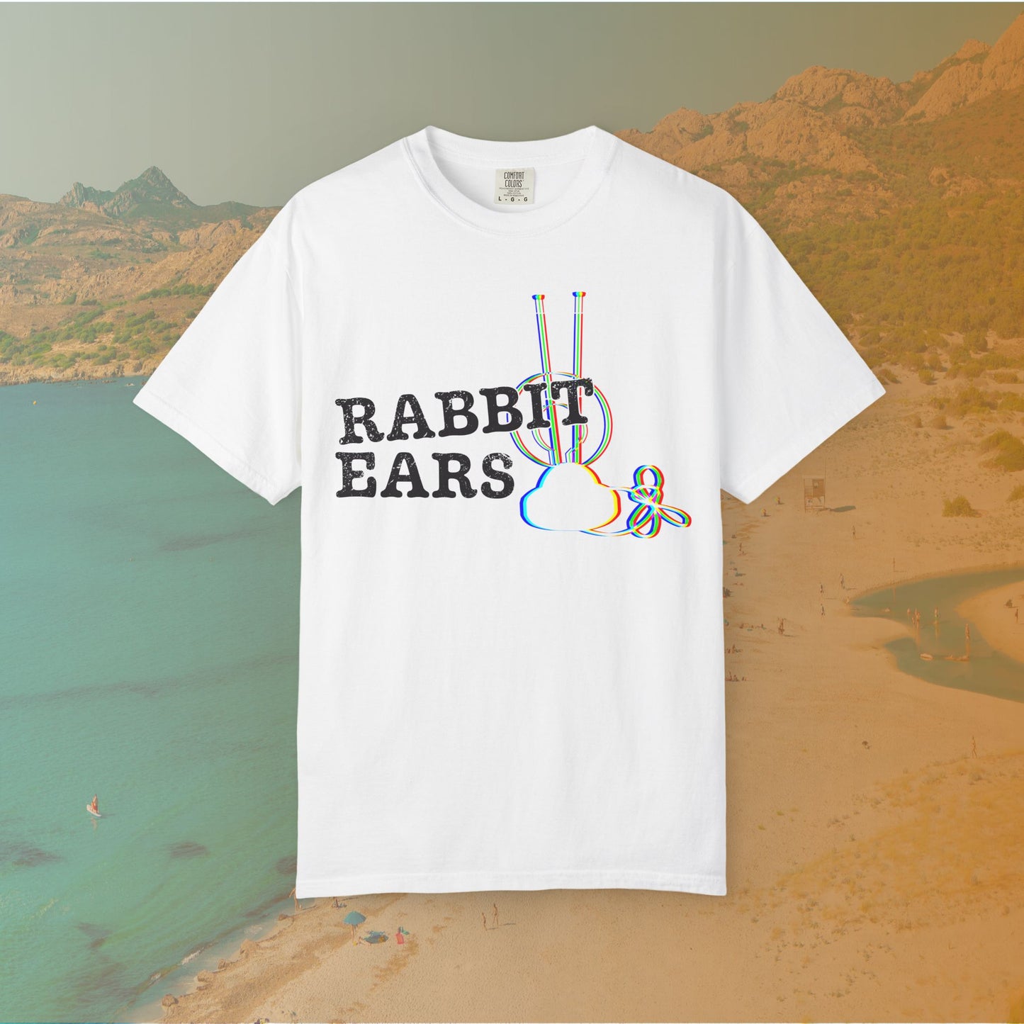 white t-shirt distressed EDM music festival text "RABBIT EARS" next to a graphic of a vintage TV antenna and cloud shape with a red, green, and blue (RGB) chromatic aberration/glitch effect, with an RGB shift design