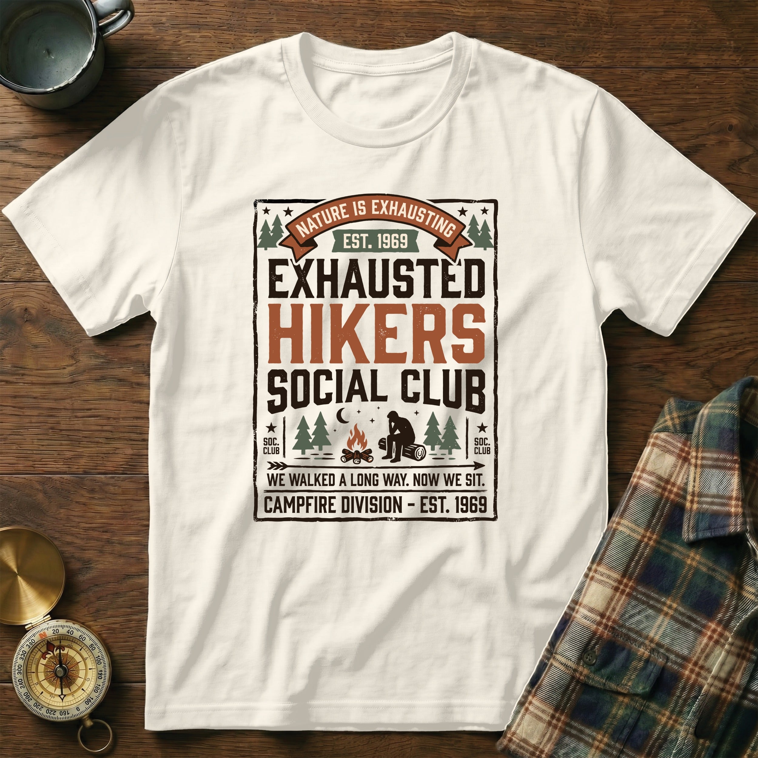 White t-shirt with "Exhausted Hikers Social Club" nature graphic.
