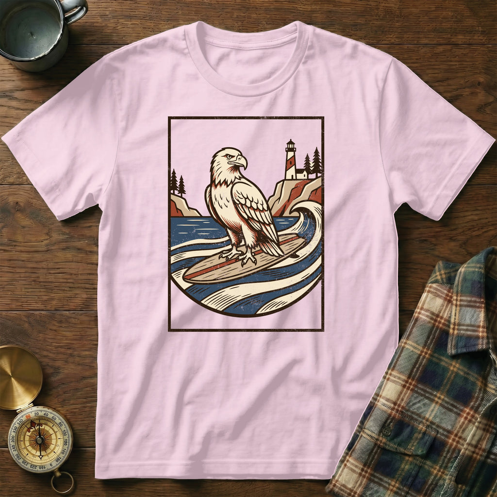 Eagle surfing on a wave with lighthouse and trees in vintage style graphic.