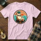 Pink t-shirt with a circular graphic of a smiling cocktail drink wearing sunglasses on a beach.