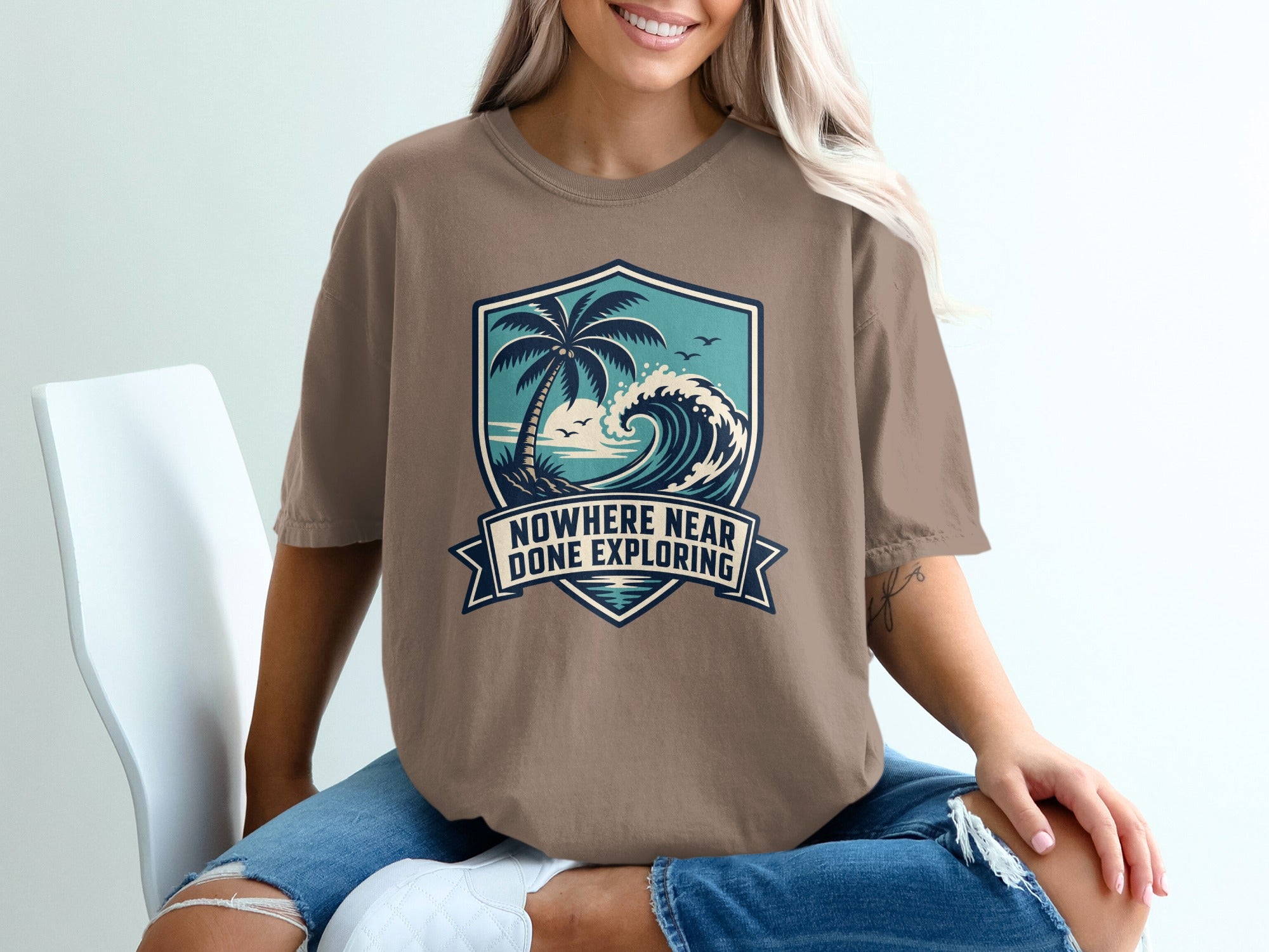 T-shirt with coastal graphic and text "Nowhere Near Done Exploring."