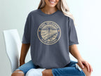 T-shirt with "Tidal Influence Silent Resistance" text and ocean landscape graphic.