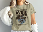 T-shirt with "Avoid Survival Situations" and outdoor graphic.
