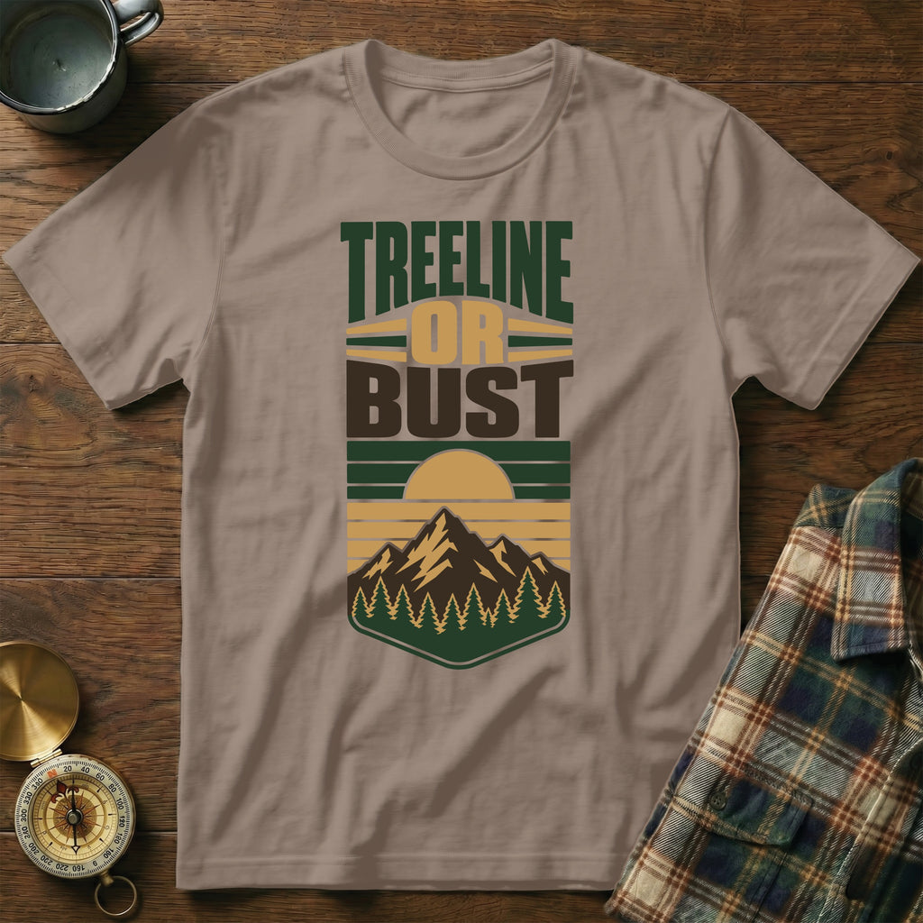 Brown t-shirt with graphic text "Treeline Or Bust" and mountain sunset design.
