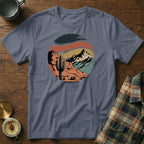 Circular desert landscape graphic with cactus and mountains on a grey t-shirt.