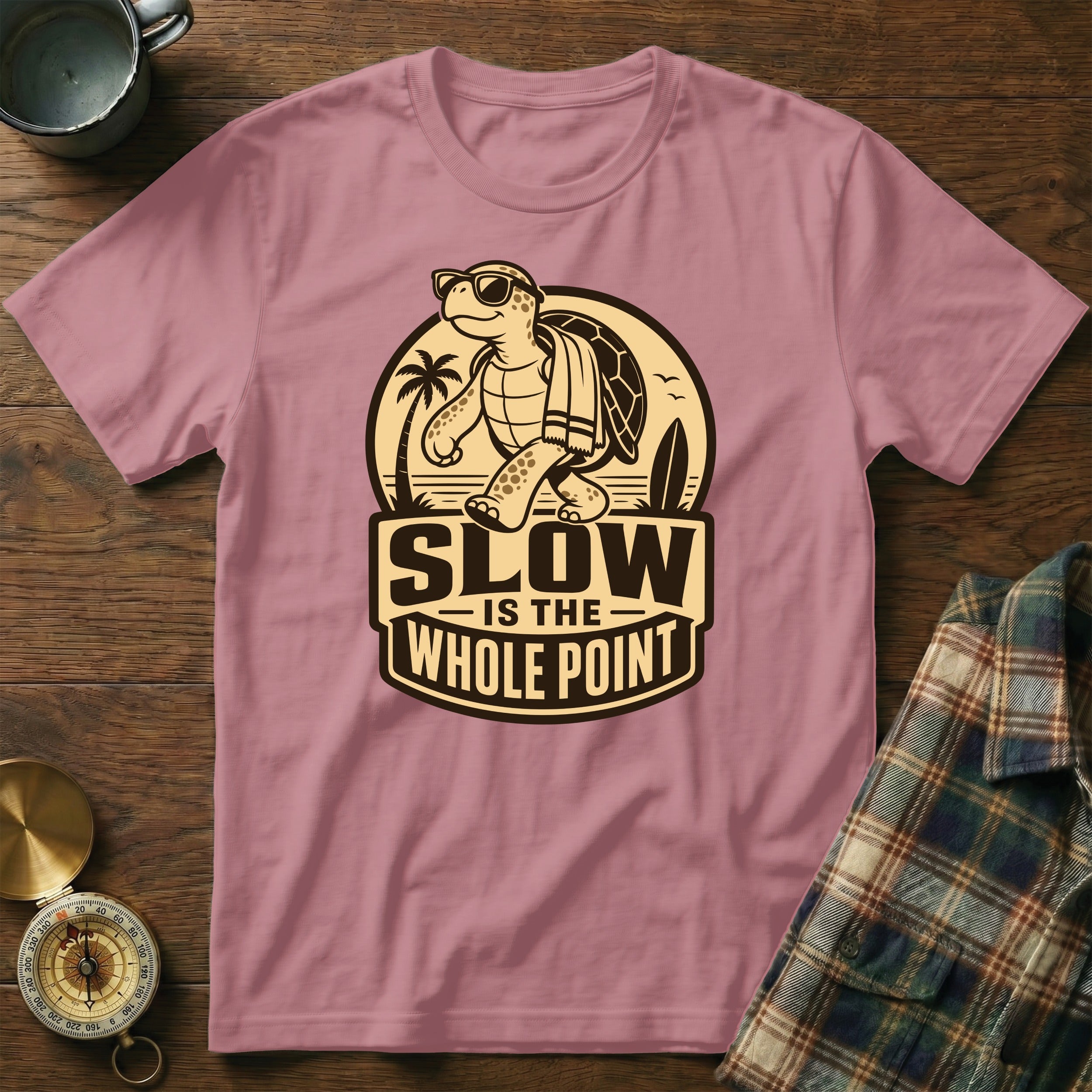 Pink t-shirt with graphic of turtle and text "SLOW IS THE WHOLE POINT".