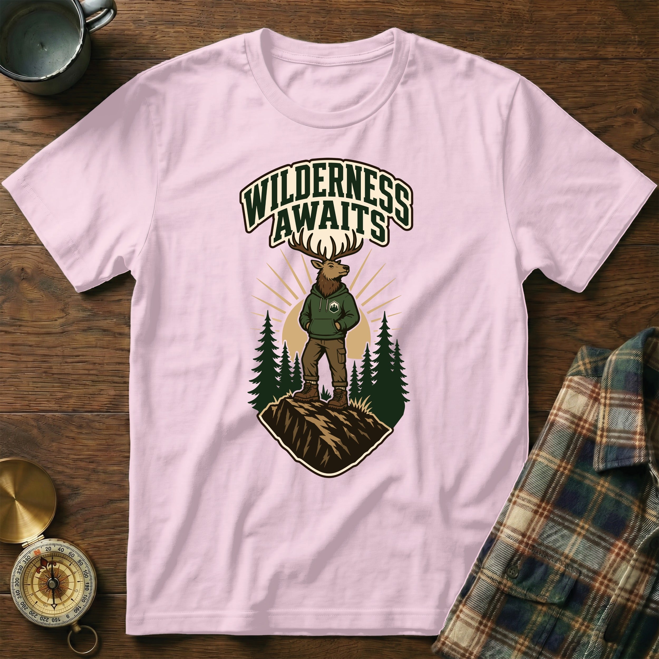 Pink t-shirt with illustration of deer wearing a hoodie and text "WILDERNESS AWAITS".